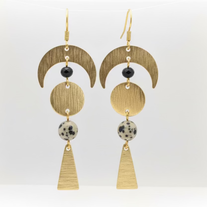 Pair of gold earrings with geometric designs on a white background