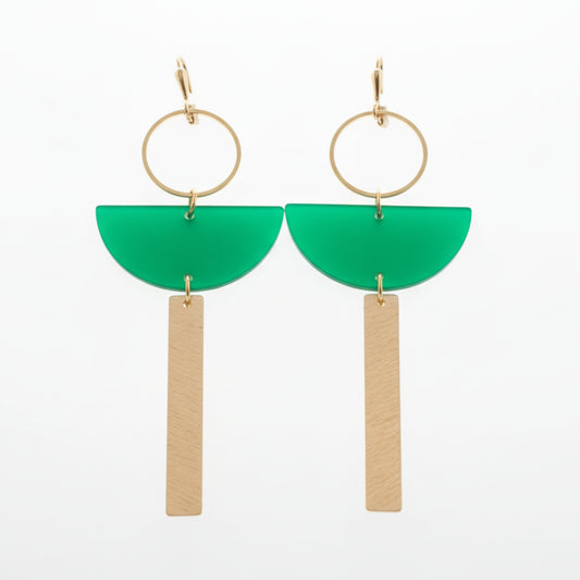 Pair of earrings on a white card with green accents, set against a white background.
