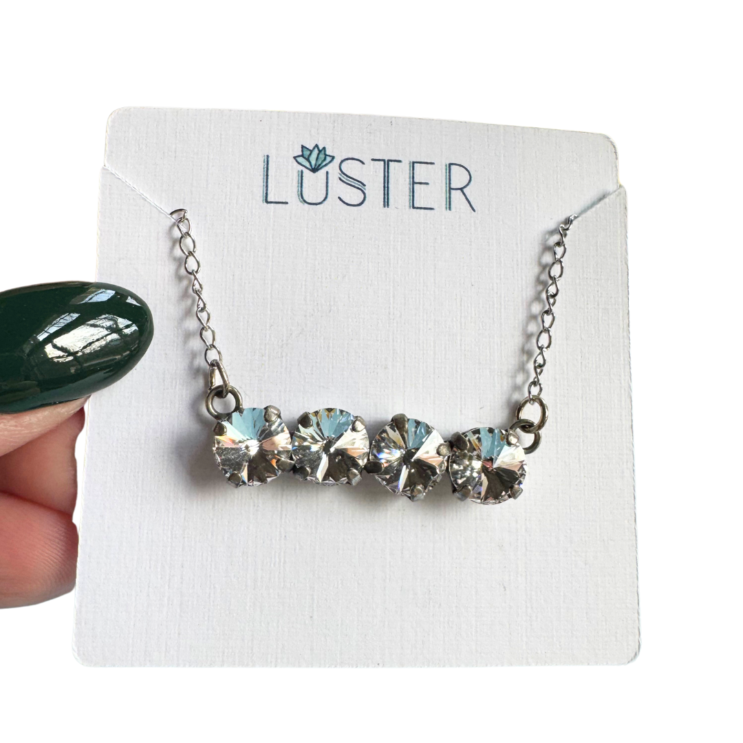 Necklace with clear crystals on a Luster branded card