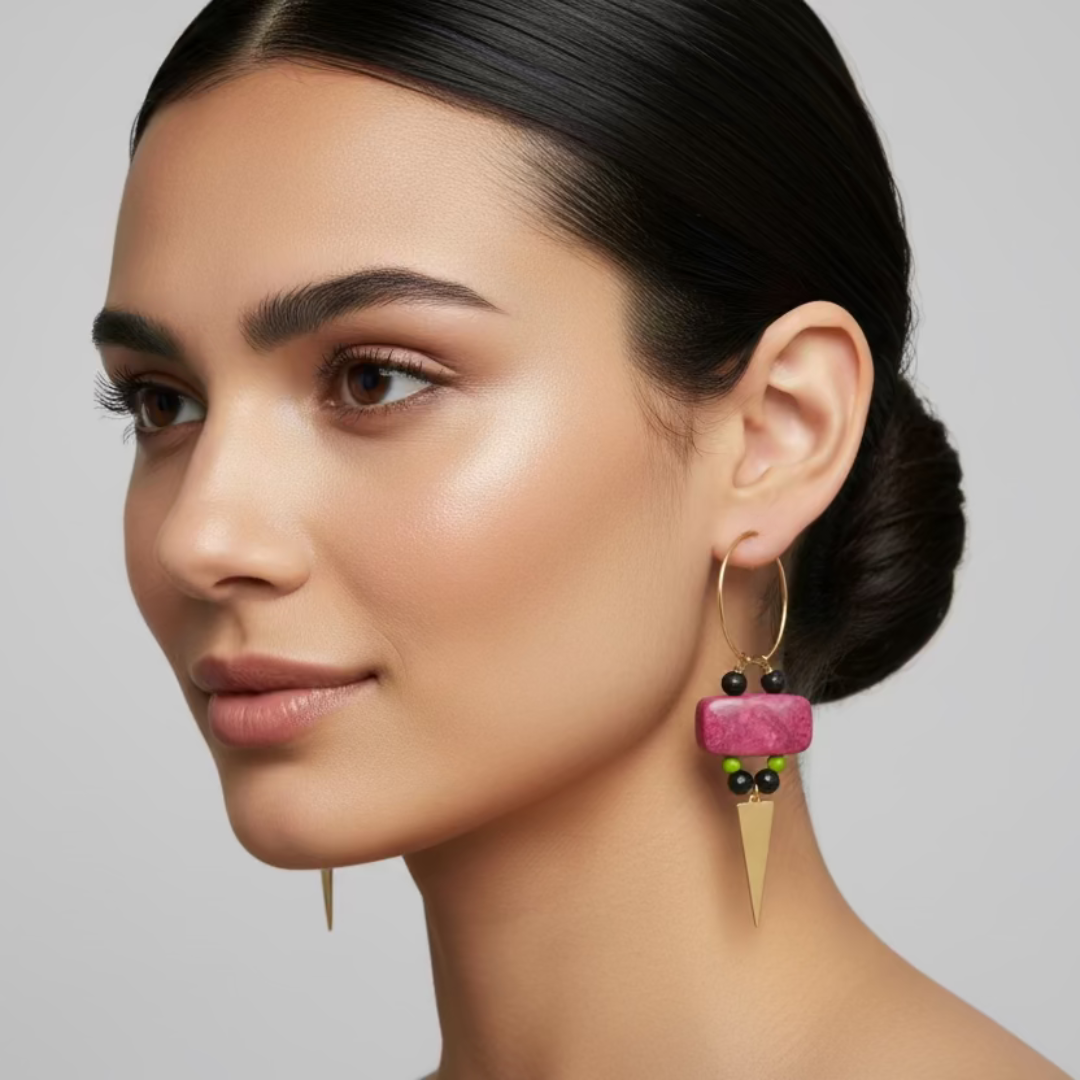 Woman wearing pink earrings with a neutral background