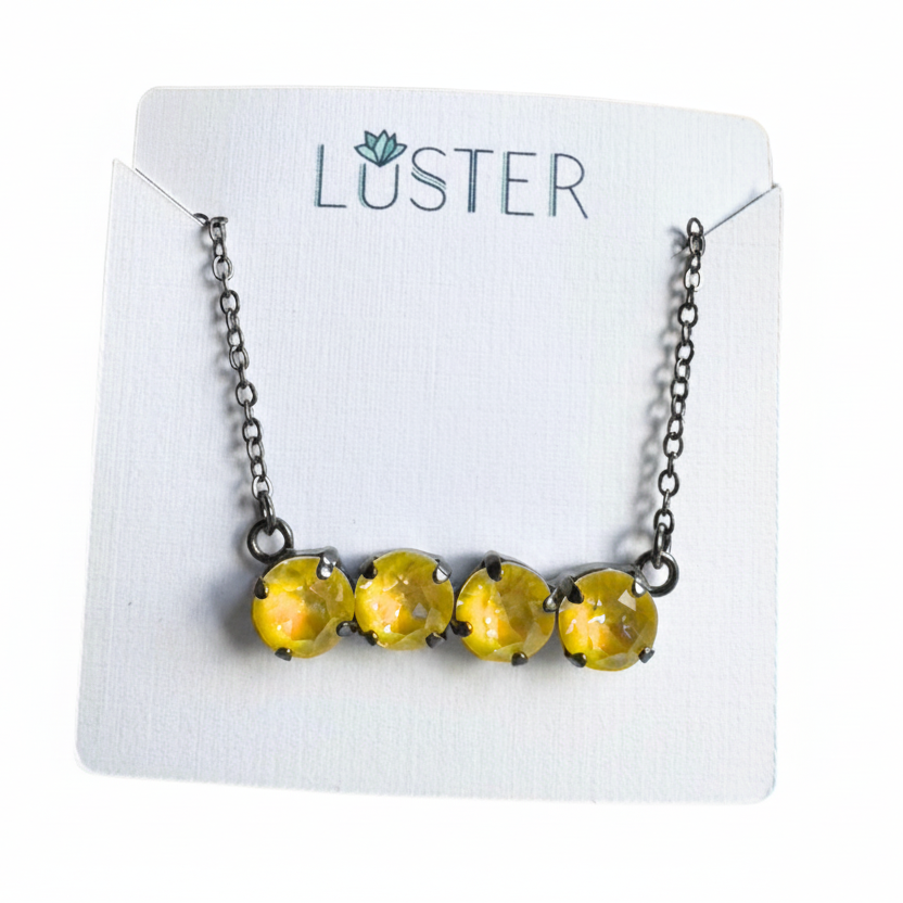 Necklace with yellow crystals on a Luster branded card