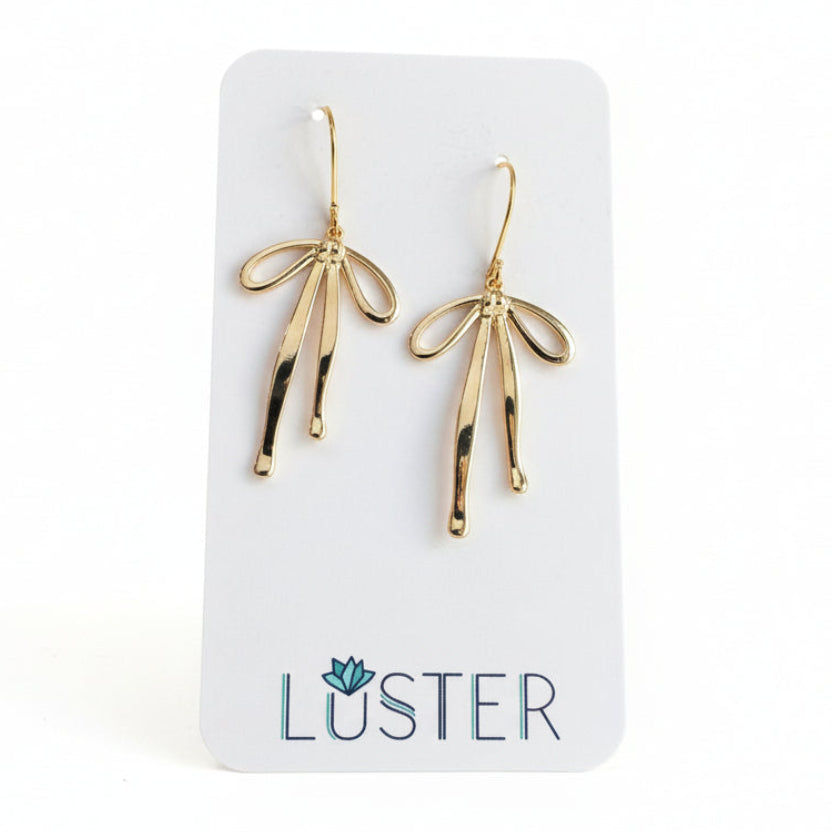 shiny gold-plated brass bowtie earrings on a white branded card