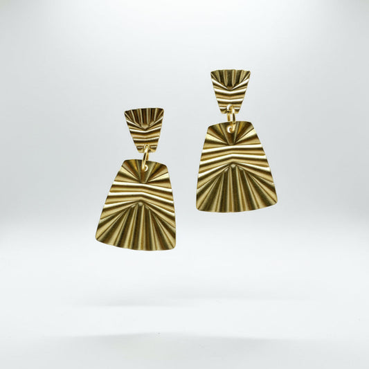 Pair of gold earrings on a white background