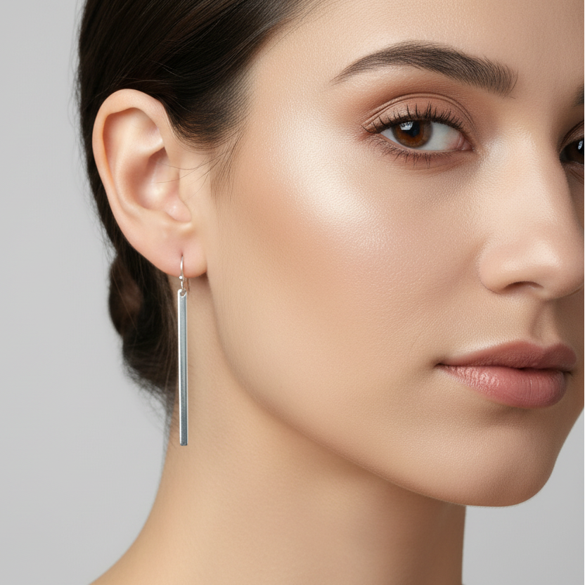Shiny silver bar earrings on a woman