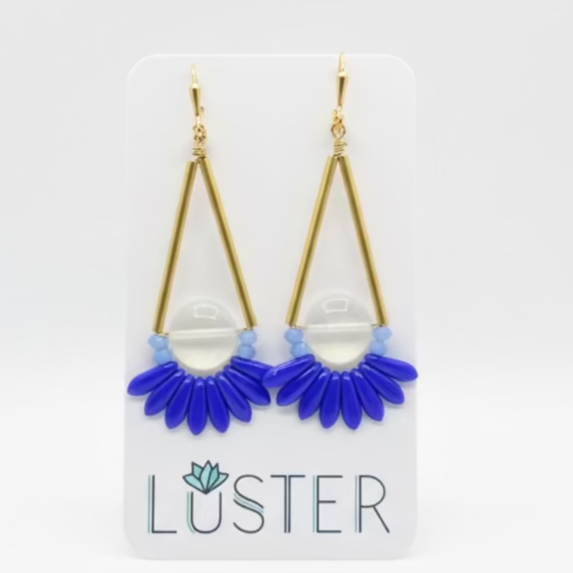 Gold and blue earrings on a Luster branded card against a white background