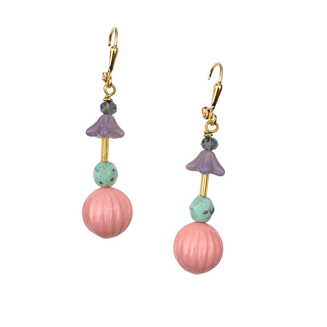 Pair of earrings with pink and purple beads on a white background