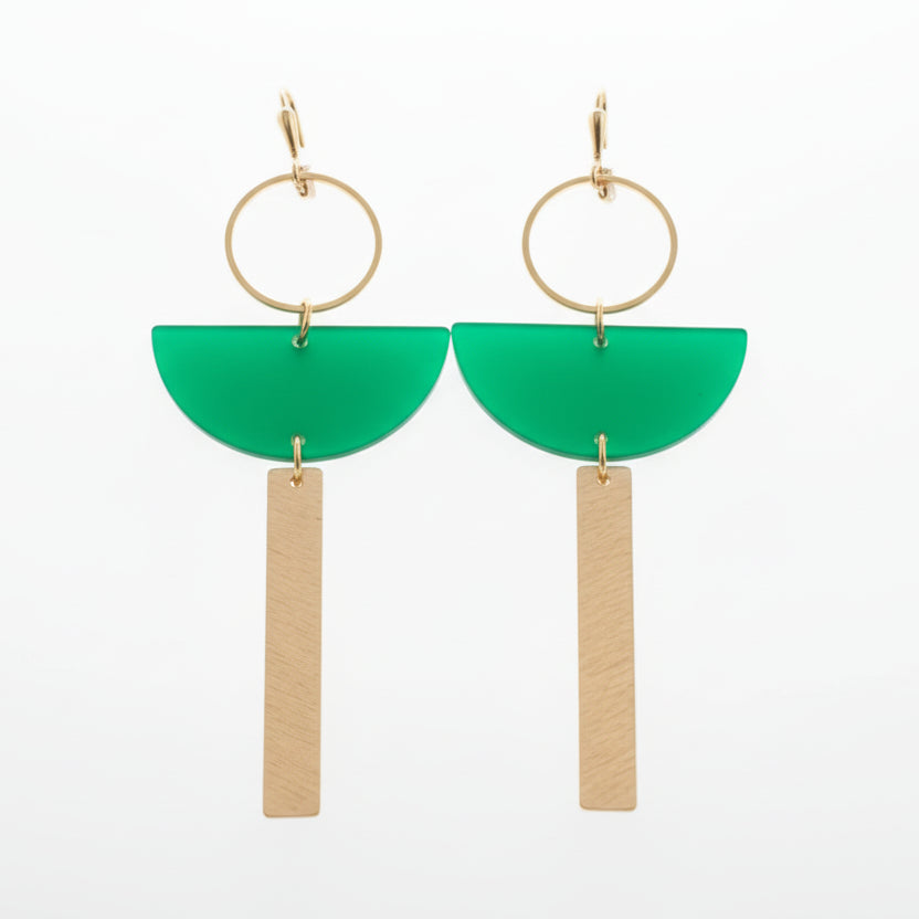Pair of earrings on a white card with green accents, set against a white background.