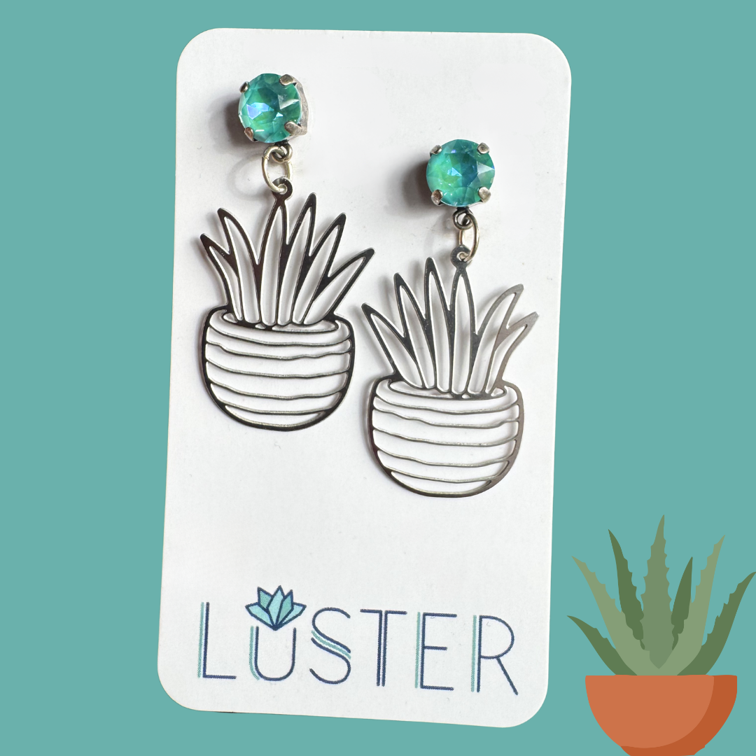 Potted plant-shaped earrings on a Luster branded card with a teal background