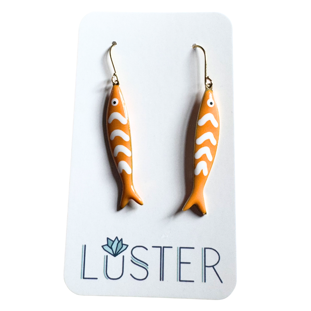 Fish-shaped earrings on a Luster branded card
