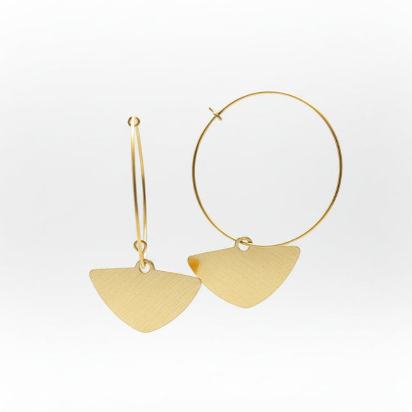 Gold hoop earrings with triangular pendants on a white background