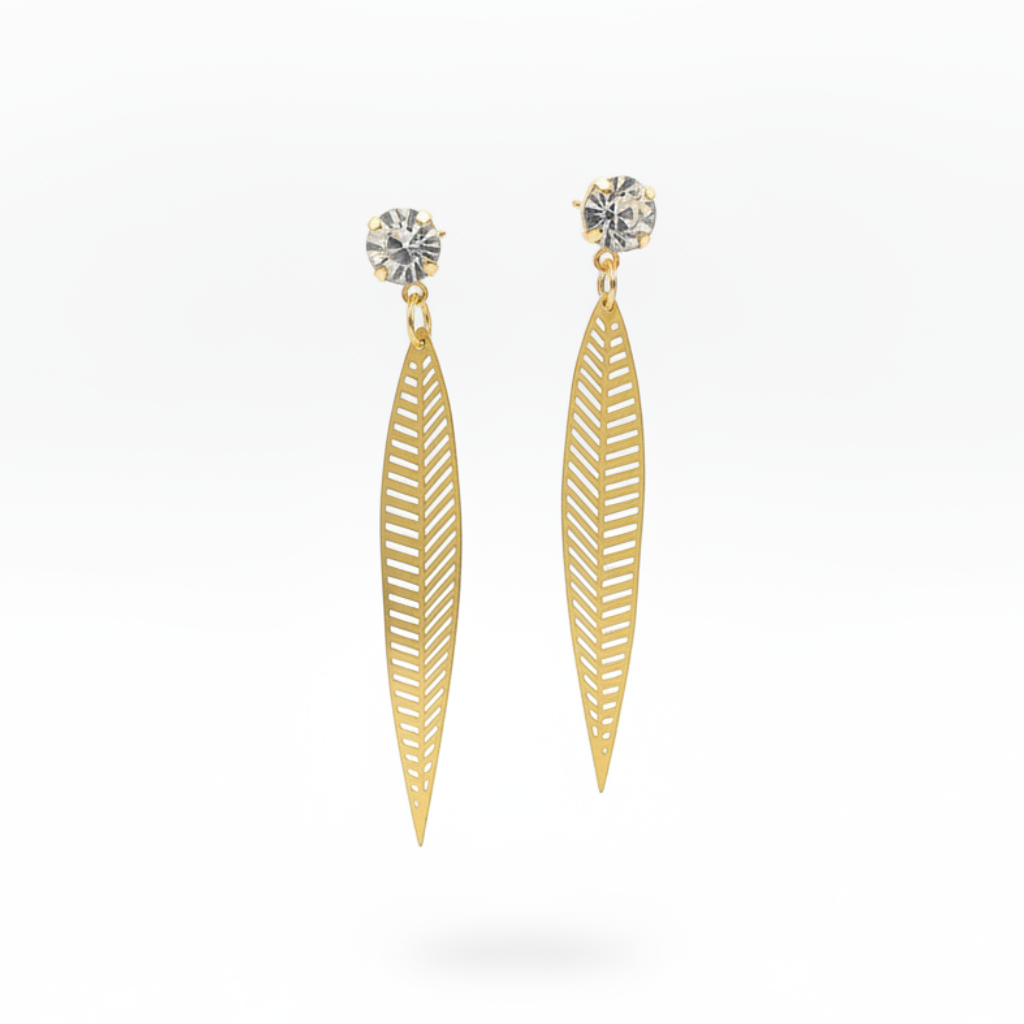 A pair of gold dangle earrings with a leaf-shaped cutout design and a clear round gemstone at the top, shown against a plain white background.