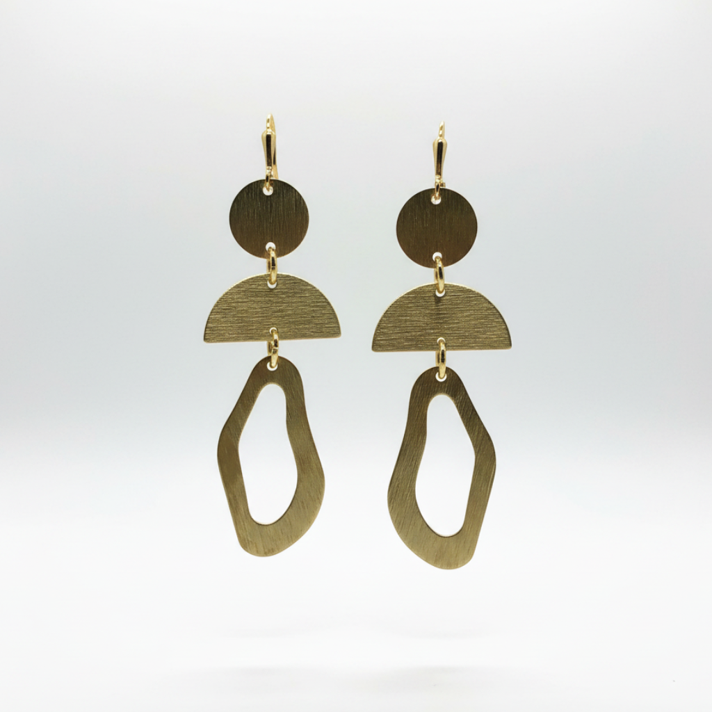 A pair of abstract geometric dangle earrings made of brushed and polished brass-toned metal, featuring circular, semi-circular, and irregular open-link shapes, shown against a clean white background.