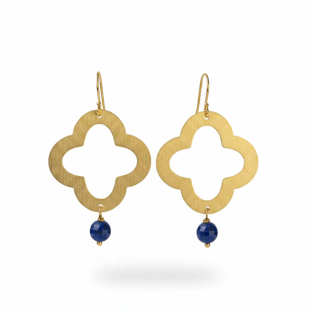 A pair of gold brass clover-shaped dangle earrings with a small round lapis bead hanging from each earring, shown against a plain white background.