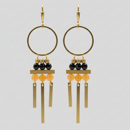 Pair of gold and blue hoop earrings on a light gray background