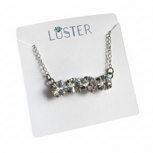 Necklace with clear crystals on a Luster branded card