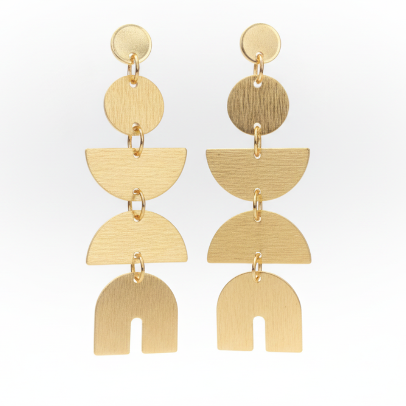 Gold geometric earrings on a Luster branded card against a white background