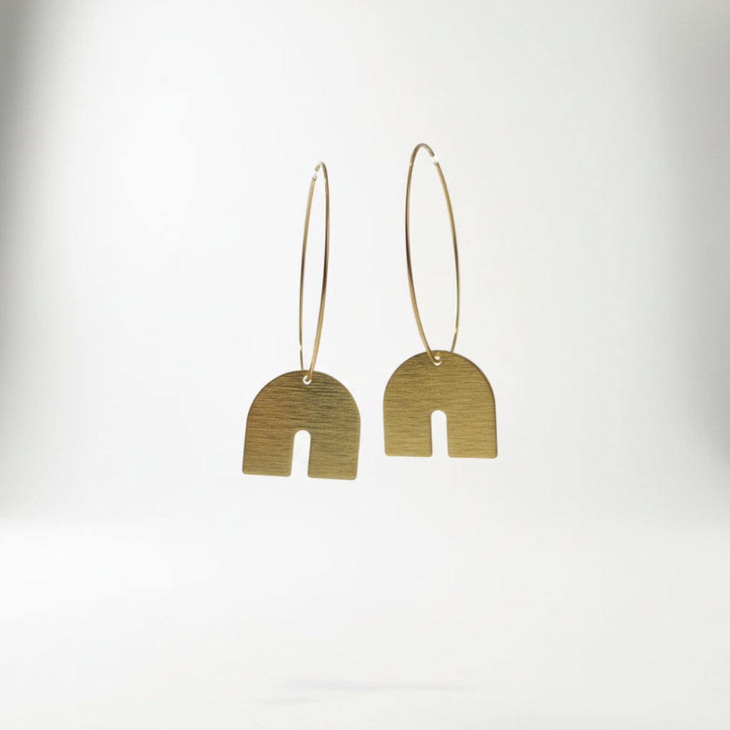 Pair of gold hoop earrings with arch-shaped pendants on a white background