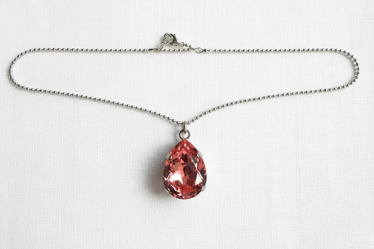 Necklace with peach crystal teardrop on silver ball chain