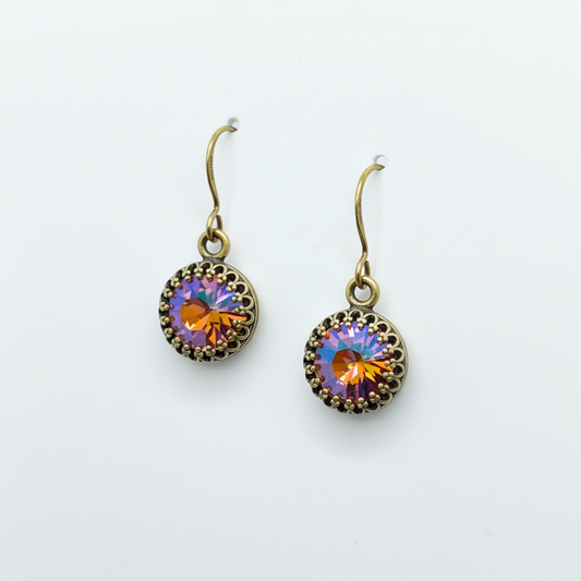 Round earrings with multicolored gemstones on a white background