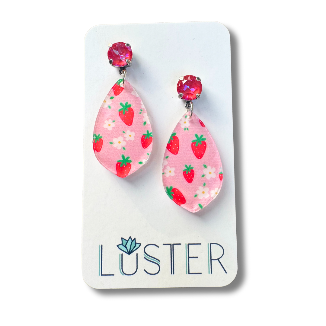 Pink strawberry patterned earrings on a Luster branded card