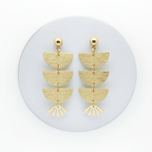Brass mixed shape drops on a bright white background.