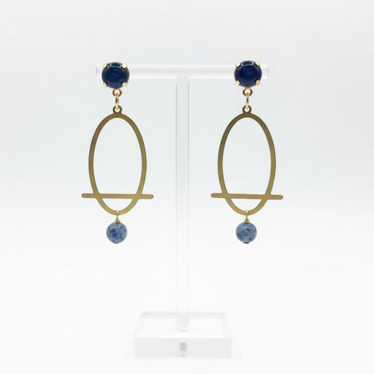 Pair of gold earrings with blue stones on a white background