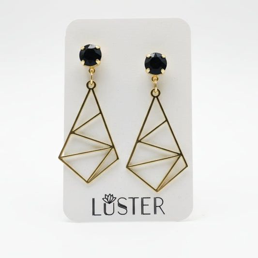 Gold geometric earrings on a Luster branded card against a white background